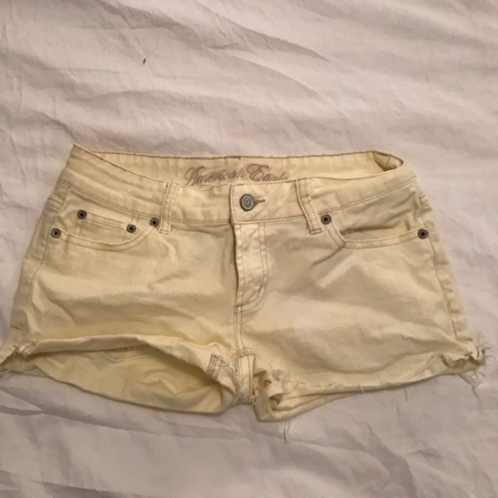 Light yellow pastel denim distressed cutoffs